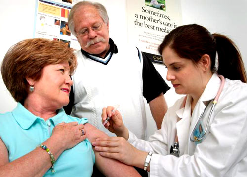Image of two seniors getting a flu shot -- CDC Public Health Image Library No9306
