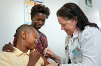 Image of an African American youth getting a flu shot -- CDC Public Health Image Library