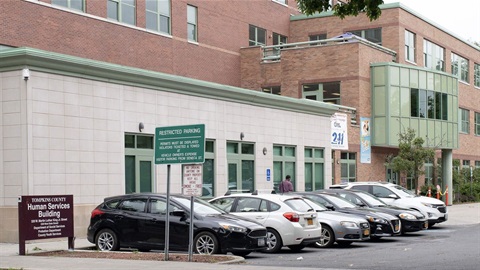 Multi-story building with cars in front of it .jpg