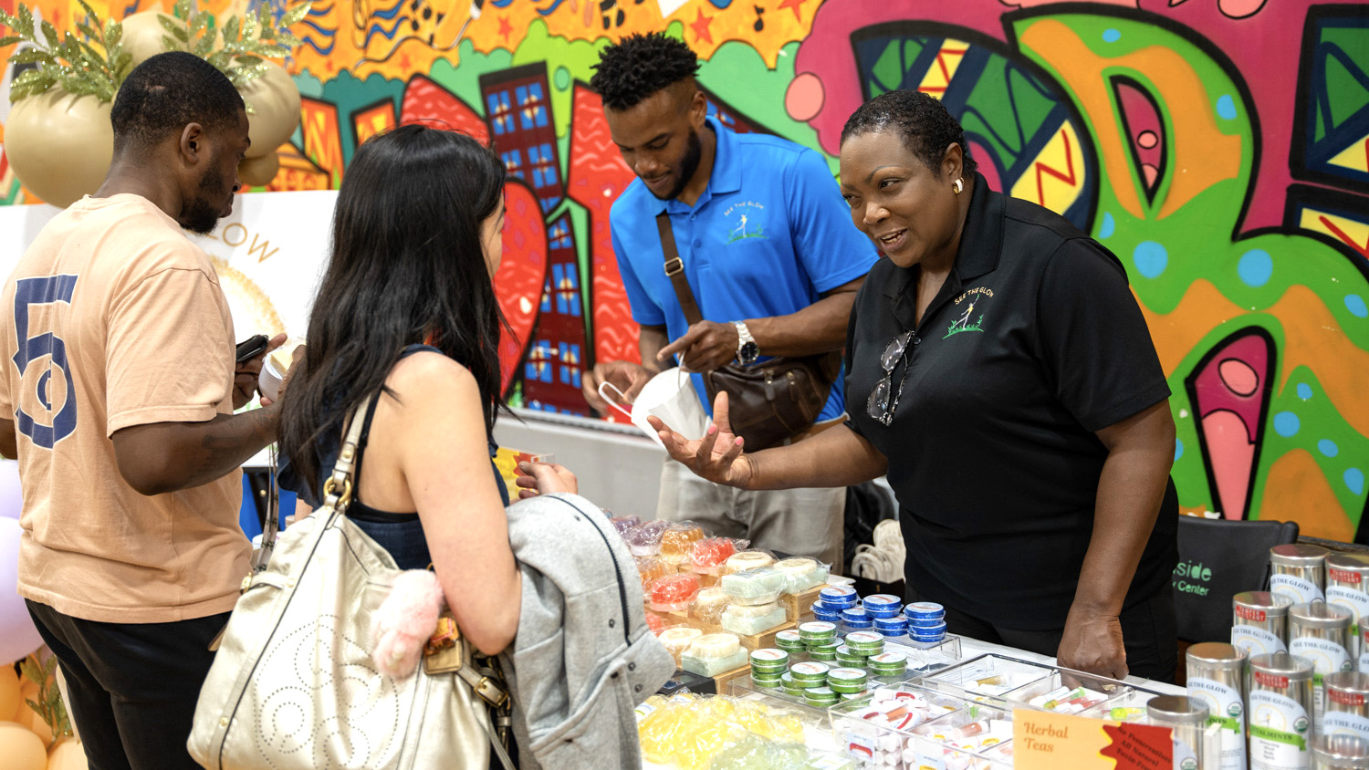 A visitor speaking with a woman tabling at a Juneteenth event in Ithaca, 2023 