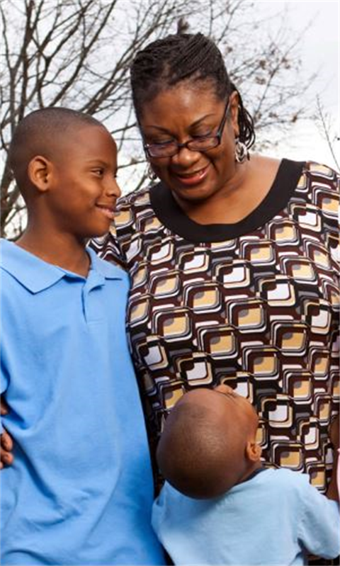 Older family member looking at two youths who are looking up to them