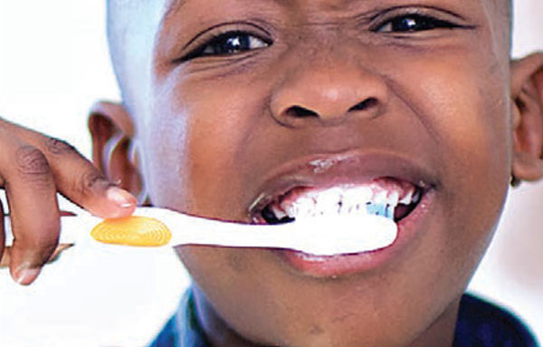 African American boy brushing his teeth